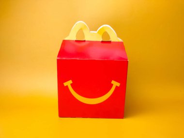 Perak,Malaysia,Febuary 2 2023: Happy Meal box from McDonald on a yellow background.