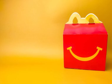 Perak,Malaysia,Febuary 2 2023: Happy Meal box from McDonald on a yellow background.