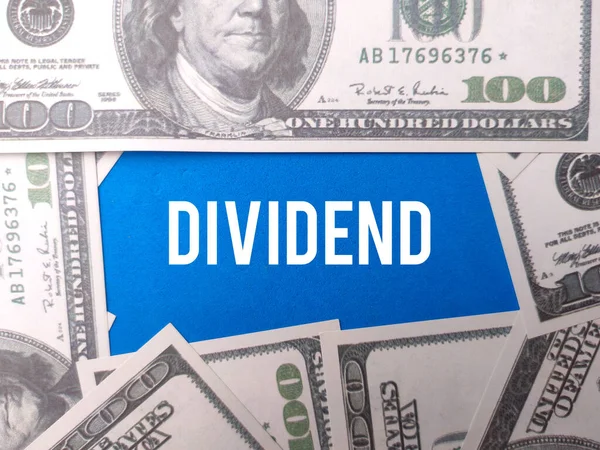 stock image Banknotes with the word DIVIDEND on a blue background