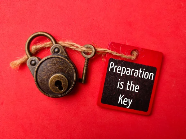 Padlock and key with the word Preparation is the key on a red background. Business concept.