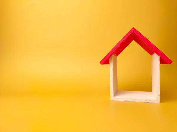 stock image Toy house isolated on yellow background with copy space