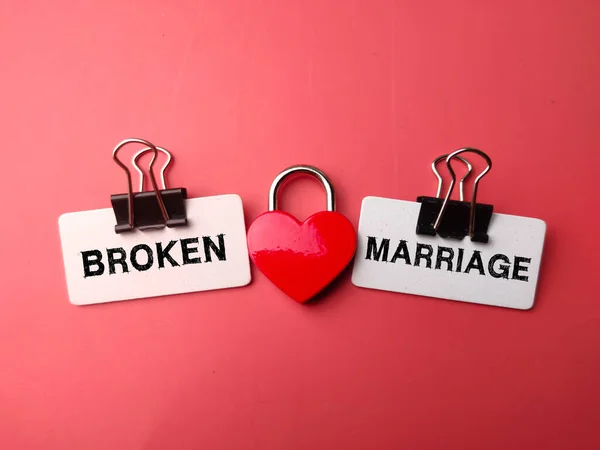 Love padlock with the word BROKEN MARRIAGE on red background