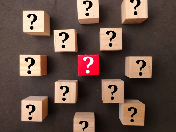 Wooden cubes with question mark icons. the concept of questions and answers
