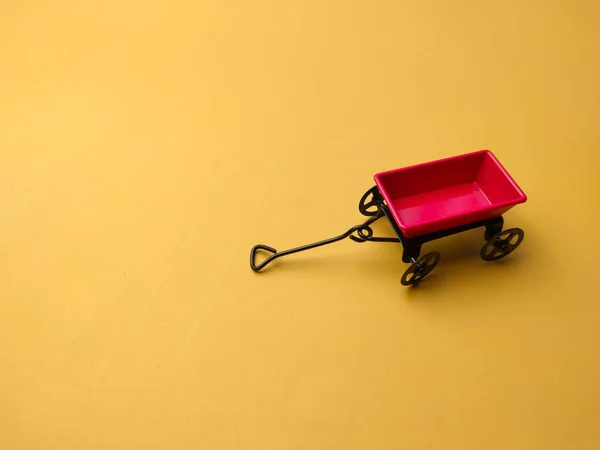 stock image Miniature garden metal and gold bar on a yellow background with copy space.