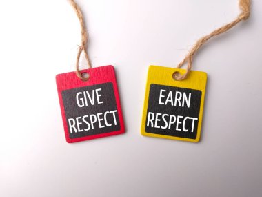 Wooden board with the word GIVE RESPECT EARN RESPECT on white background clipart