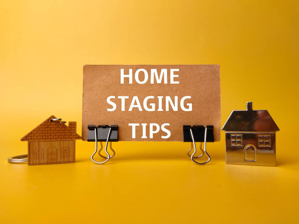 House keychain and card board with the word HOME STAGING TIPS on yellow background