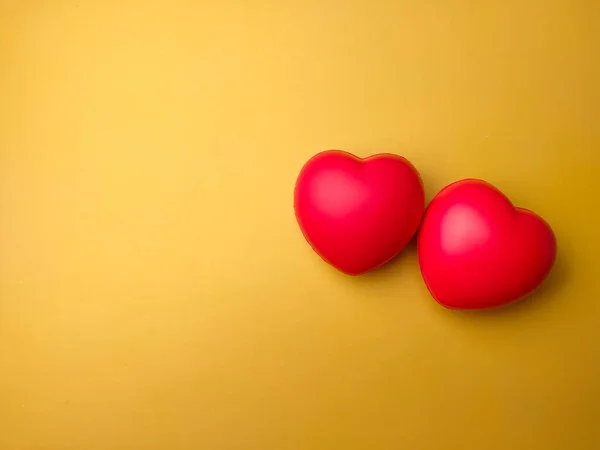 Top view two red heart shape on yellow background with copy space. Can use for heart check up or love concept