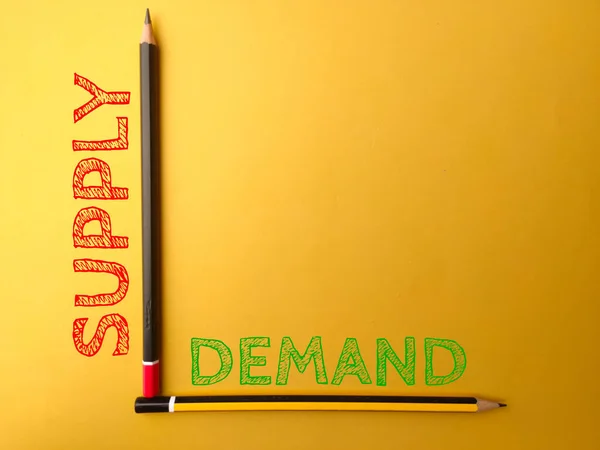 Two pencil with the word SUPPLY DEMAND on yellow background