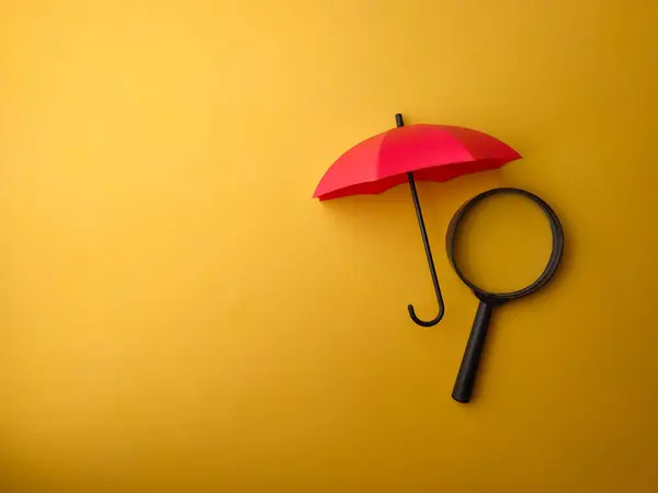 Piros Esernyővel Borított Nagyító Sárga Alapon — Stock Fotó