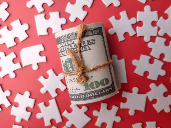 stock image Top view banknotes and white puzzle on a red background