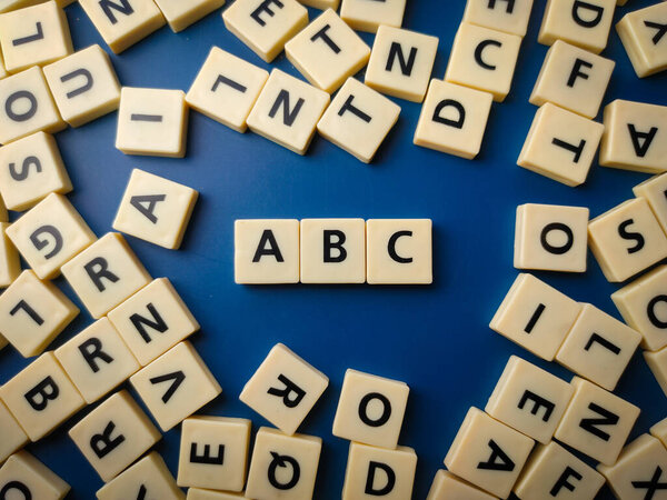 Closeup toy letters arranged the word ABC with a blue background.