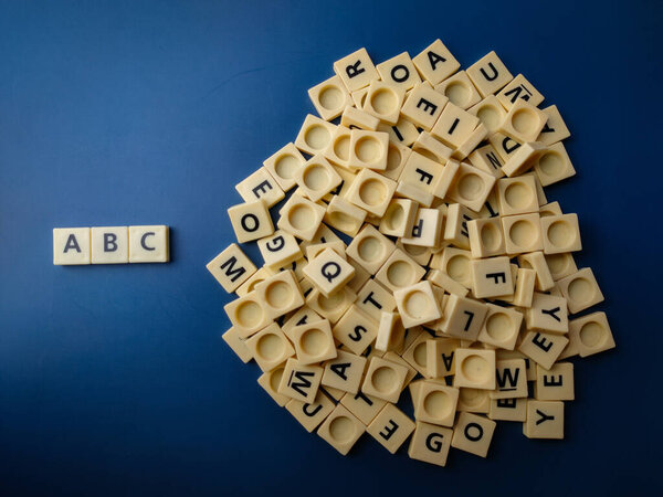 Top view toy letter arranged the word ABC with a blue background.