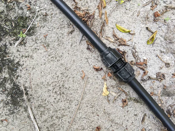 stock image Top view of the black poly pipe that is on the ground after being repaired.