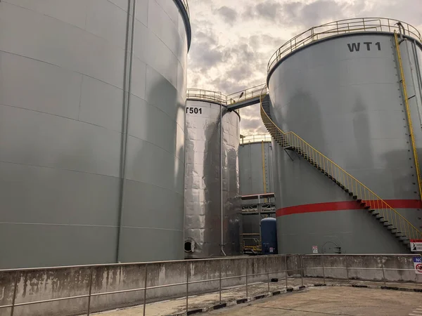 A water storage tank next to an oil storage tank in a factory