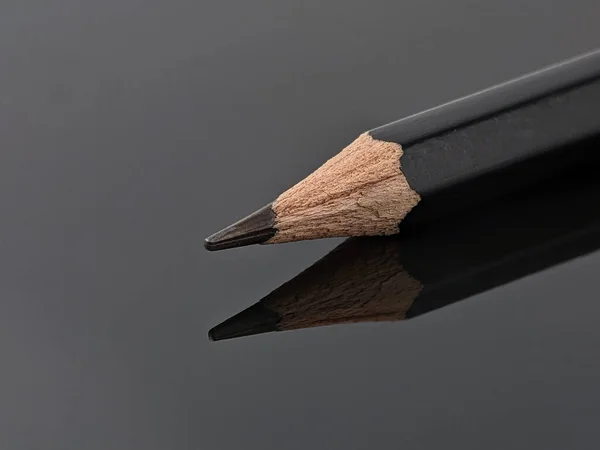 Detailní Záběr Černé Tužky Odrazem Černé Akrylové Desce — Stock fotografie