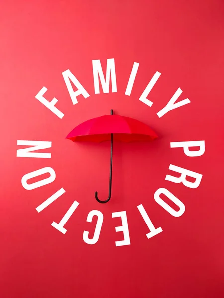 Red umbrella with the word FAMILY PROTECTION on a red background