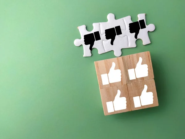 stock image White puzzle and wooden cubes with good and bad hand icons. Thump up and thump down.