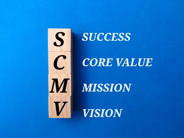 Wooden cube with the words VISION MISSION CORE VALUES and SUCCESS