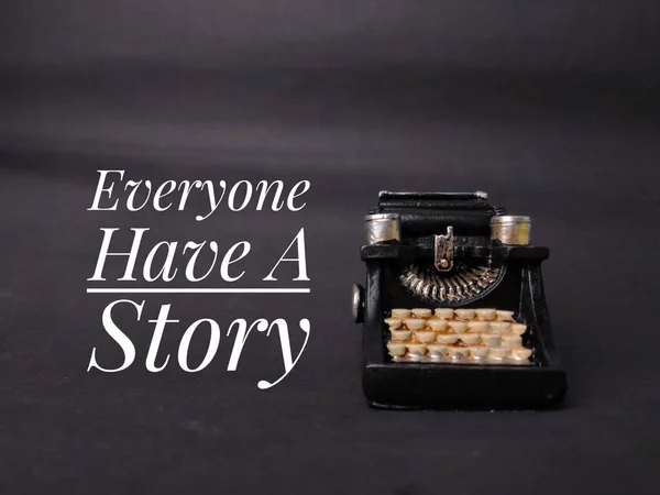 Vintage black typewriter with text Everyone Have A Story on the black background