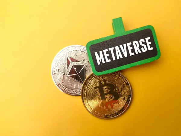 stock image Top view colored board with text METAVERSE and silver ethereum and golden bitcoin digital crypto coin on yellow background