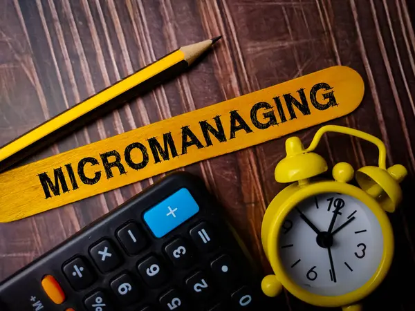 stock image Pencil,calculator,clock and colored ice cream stick with text MICROMANAGING.