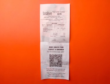 Perak, Malaysia- July 29 2024: Top view receipt for the purchase of Tealive drinking water on an orange background. clipart