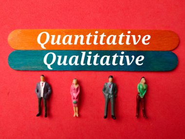 Miniature people with the word quantitative and qualitative on a red background. clipart