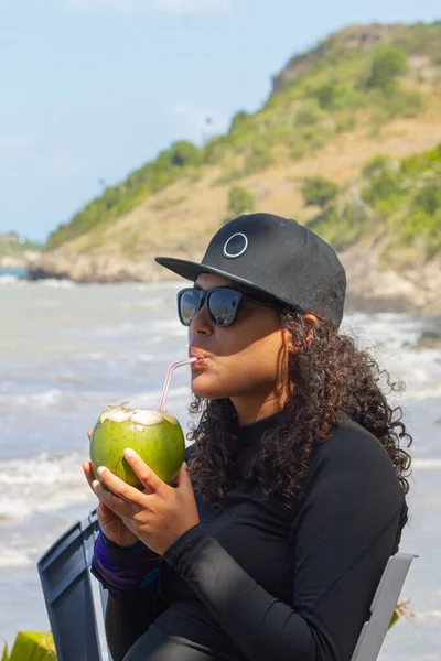 Woman with a glass of wine and a book at the beach on the ocean. summer holiday vacation concept