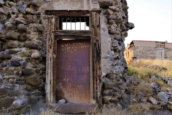 An old door and a demolished wall near Erzurum Castle in Turkey.(Turkish: Erzurum Kalesi).Turkey travel. Islamic ancient building.