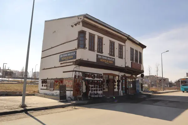 Erzurum, Türkiye. Geleneksel hediyelik eşya dükkanı, gün ışığında yıkanmış, tarihi Al-Manaratain Okulu 'nun yanında duruyor. Kültür, miras ve özgün el yapımı sanatların mükemmel bir karışımı..
