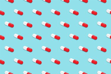 Pharmaceutical medicine pills. Capsule pattern isolated on blue background. Medicine creative concept