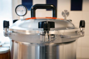 Close up of the lid to a pressure canner. Food preservation is key to gardening and homesteading. Pressure canning makes food shelf stable.  clipart