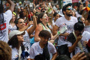 Bloco Os Capoeiras parade through the streets of Vila Madalena in Sao Paulo. February 18, 2023. Sao Paulo, Brazil: - Led by percussionist and capoeirista Mestre Dalua, Os Capoeira 