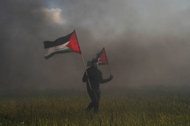 Palestinians demonstrate on the borders of the Gaza Strip. February 22, 2023, Gaza, Palestine: Palestinian youth set fire to rubber tires on the eastern borders of the Gaza Strip