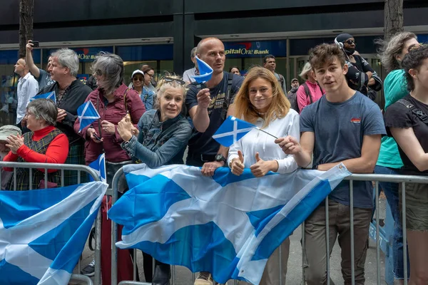 stock image 25th Annual New York City Tartan Day Parade. April 15, 2023, New York, New York, USA: Spectators holding Scottish flags cheer on participants at the 25th Annual Tartan Day Parade in Manhattan on April 15, 2023 in New York City.  