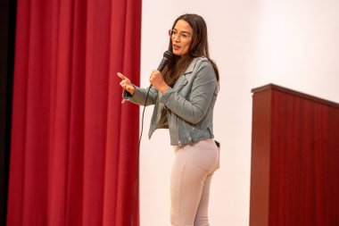 Alexandria Ocasio-Cortez Town Hall. May 26, 2023, New York, New York, USA: U.S. Representative Alexandria Ocasio-Cortez speaks at a town hall meeting at the Corona Arts and Sciences Academy on May 26, 2003 in the Queens borough of New York City clipart