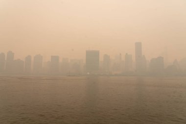 Kanada 'daki orman yangınlarından çıkan duman güneye doğru esiyor ve 7 Haziran 2023' te, New York, New York, ABD 'de New York City' nin gökyüzü alevler altında kalıyor. 