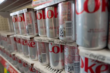 (NEW) Artificial Sweetener Aspartame Possible Carcinogen. June 30, 2023, New York, New York, USA: Cans of Diet Coke carbonated diet drinks on a retail shelf on June 30, 2023 in New York City.  clipart