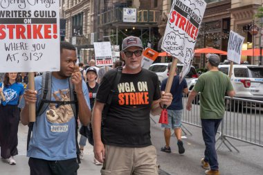 Writers Guild of America picket. August 15, 2023, New York, New York, USA: Striking members of Writers Guild of America and supporters walk on a picket line outside Netflix and Warner Bros./ Discovery office on August 15, 2023 in New York City. clipart