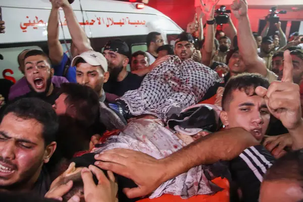 Stock image September 13, 2023, Gaza, Palestine: Palestinians carry the bodies of men killed during an explosion near the border fence with Israel. 