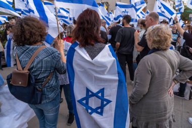 Israeli Expats and US Jews Protest During Prime Minister Netanyahu's U.N. Visit. September 19, 2023, New York, New York, USA: Protester draped in Israeli flag participates at a rally outside the Metropolitan Museum of Art  clipart