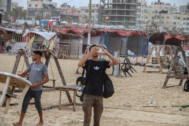 October 02, 2023 - Gaza, Palestine: Palestinians enjoying the winter weather on the Gaza City sea daily life.   clipart