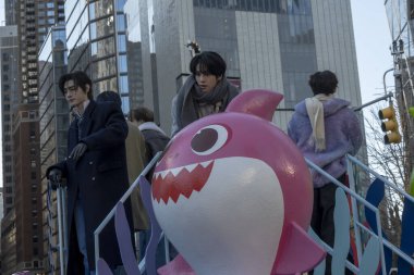 Macy's Annual Thanksgiving Day Parade Takes Place In New York City. November 23, 2023, New York, New York, USA: Enhypen band members ride the Baby Shark float during the Macy's Annual Thanksgiving Day Parade on November 23, 2023 in New York  clipart