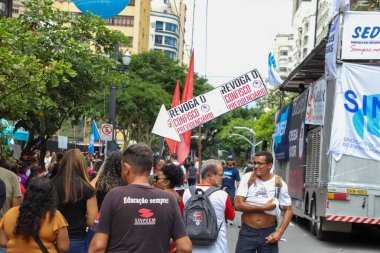 Sao Paulo, BRAZIL - 03/08/2024: Demonstration and Strike by Teachers in front of the Sao Paulo City Hall. Demands of the Coeduc Agenda for the 2024 Salary Campaign are: Increase of 39% incorporated for everyone; End of the 14% pension confiscation clipart