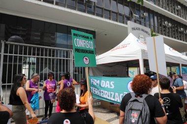 Sao Paulo, BRAZIL - 03/08/2024: Demonstration and Strike by Teachers in front of the Sao Paulo City Hall. Demands of the Coeduc Agenda for the 2024 Salary Campaign are: Increase of 39% incorporated for everyone; End of the 14% pension confiscation clipart