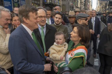 St. Patrick's Day Parade in New York City.  March 16, 2024, New York, New York, USA: (L-R) Mike Carroll, Seamus Carroll (16 Months old) and New York State Governor Kathy Hochul  clipart