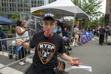 (18. Geleneksel Dans Yürüyüşü ve Festivali. 18 Mayıs 2024, New York, ABD: Her yıl düzenlenen Dans Yürüyüşü ve Festival sırasında Dans Polisi tişörtü giyen alay personeli poz veriyor. 