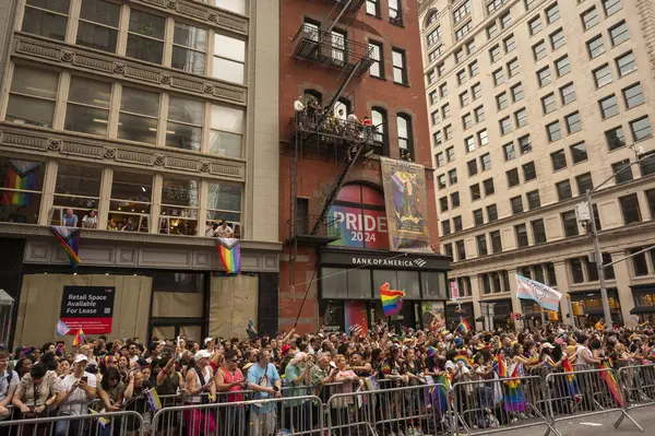 stock image (NEW) 2024 New York City Pride March. June 30, 2024, New York, New York, USA: Thousands of spectators with pride flags watch the annual New York City Pride Parade