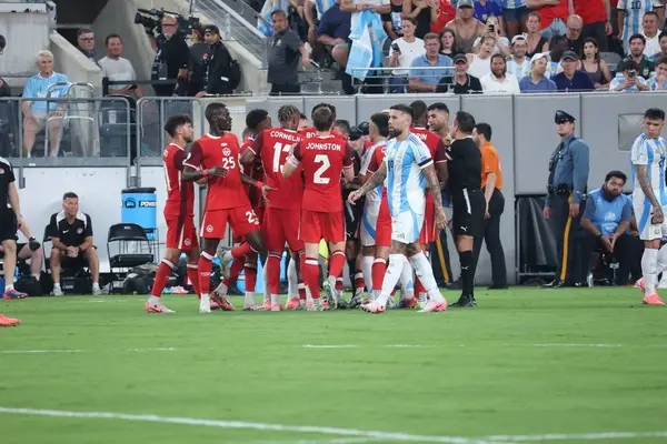 stock image Copa America Semi Final : Argentina vs Canada. July 9, 2024, East Rutherford, New Jersey, USA:  Match referee Maza Gomez Piero (Chile) gives yellow card to Canadian player which led to arguments among players during soccer match