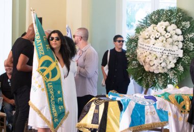 Rio de Janeiro, (RJ) Brazil 07/26/2024 - Rafaela Theodoro flag bearer of the Leopoldinense empress says goodbye to the carnival artist Rosa Magalhaes. The farewell is open to the public at Rosa Magalhaes' wake.  clipart